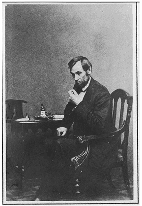 photo-0909-2013-abraham-lincoln photo of American President Abraham Lincoln seated at a small table