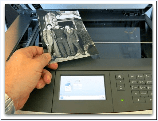 photo of an old photograph being scanned