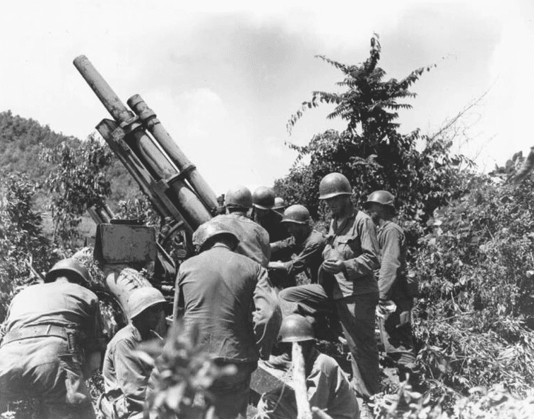 Photo: a gun crew checks their equipment near the Kum River, 15 July 1950