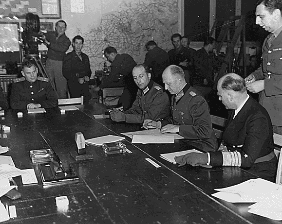 Photo: German General Alfred Jodl signs the instruments of unconditional surrender in Reims, France, on 7 May 1945