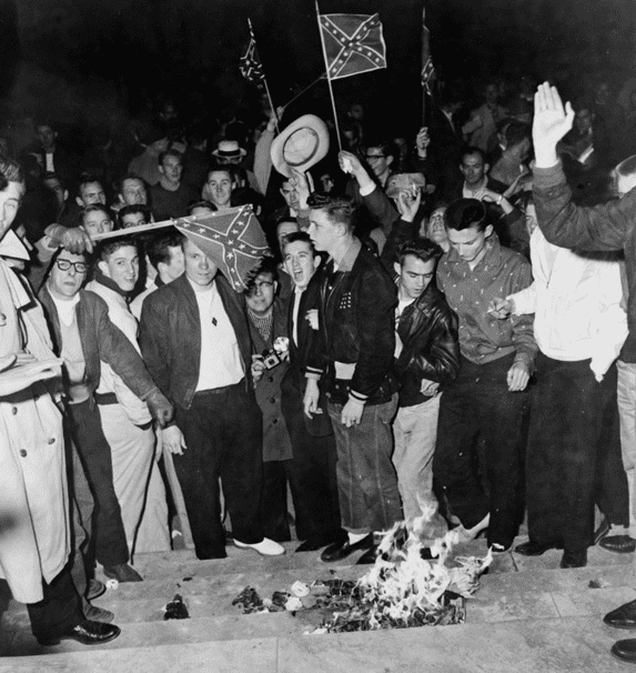 Photo: University of Alabama students burn desegregation literature during demonstration in Tuscaloosa, Alabama, 6 February 1956, against the enrollment of Autherine Lucy, an African American student