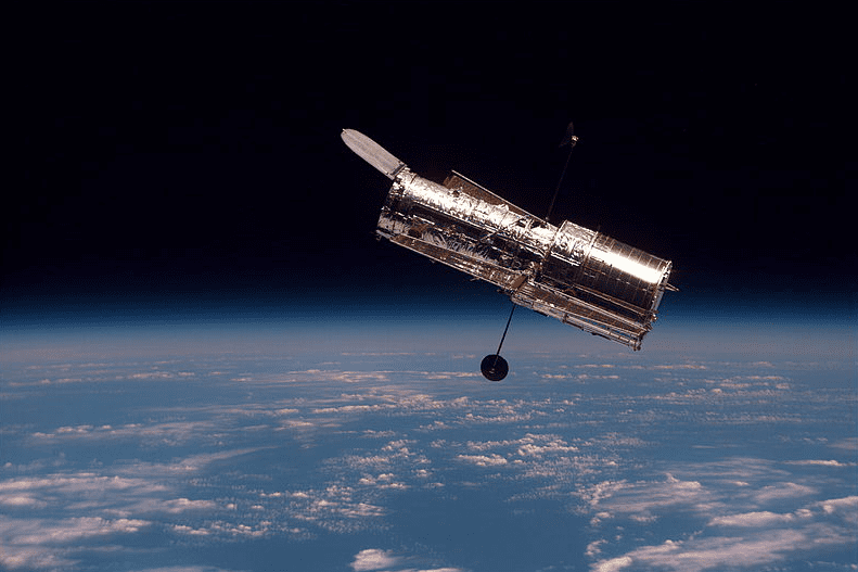Photo: the Hubble Space Telescope as seen from the space shuttle Discovery during its second servicing mission, 19 February 1997
