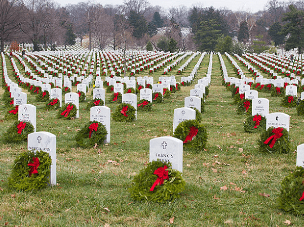 Photo: wreaths laid at Arlington National Cemetery. Credit: U.S. Army photo by Spc. James K. McCann; Wikimedia Commons.