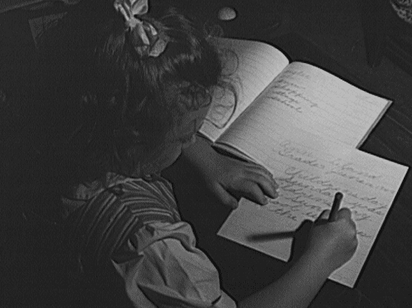 Photo: girl writing; the open notebook is her personal speller, 1943. Credit: Philip Bonn; Library of Congress, Prints and Photographs Division.