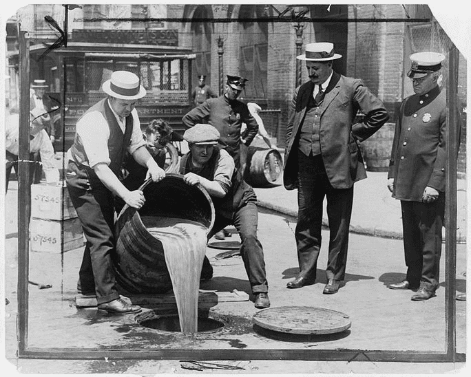 Photo: New York City Deputy Police Commissioner John A. Leach, right, watching agents pour liquor into sewer following a raid during the height of Prohibition