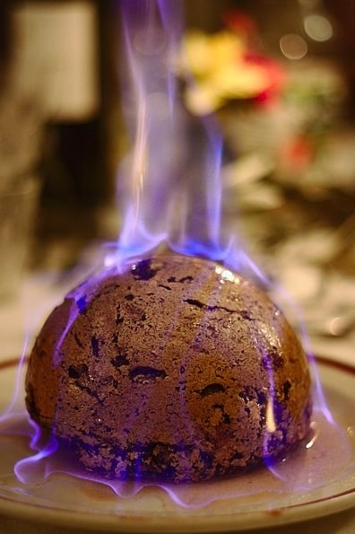 Photo: a Christmas Pudding being flamed after brandy has been poured over it