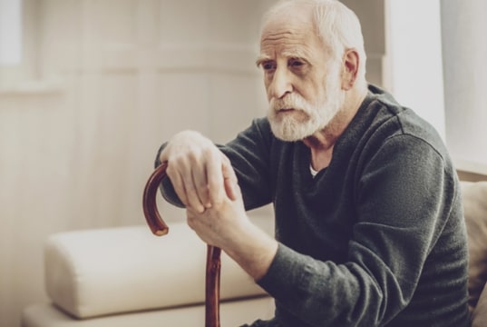 Photo: old man leaning on his cane. Credit: https://depositphotos.com/home.html