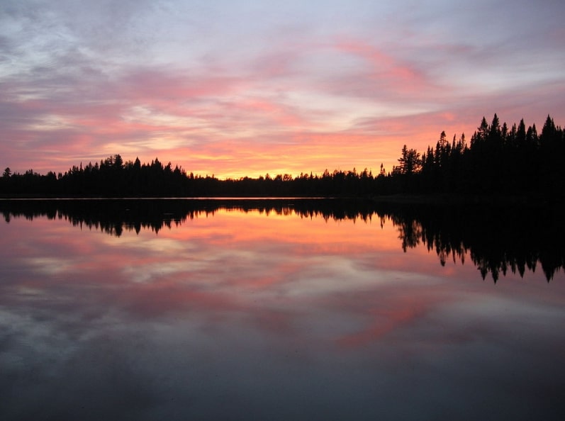 Photo: sunset over Pose Lake in the Boundary Waters Canoe Area Wilderness, Minnesota. Credit: R27182818; Wikimedia Commons.