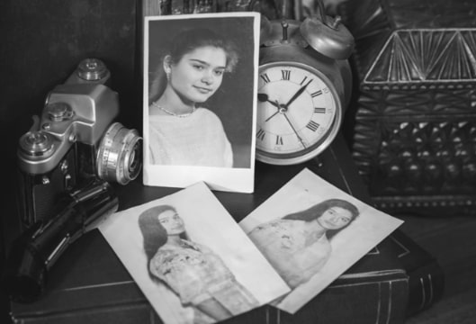 Photo: young woman photos with camera and clock. Credit: https://depositphotos.com/home.html