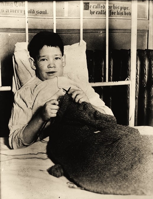 Photo: John Finnegan knitting. Credit: American National Red Cross photograph collection; Library of Congress, Prints and Photographs Division.