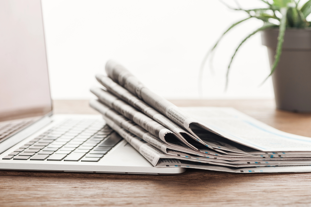Photo: newspapers and a computer.