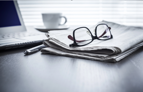 Photo: a newspaper, glasses, and a computer. Credit: https://depositphotos.com/home.html