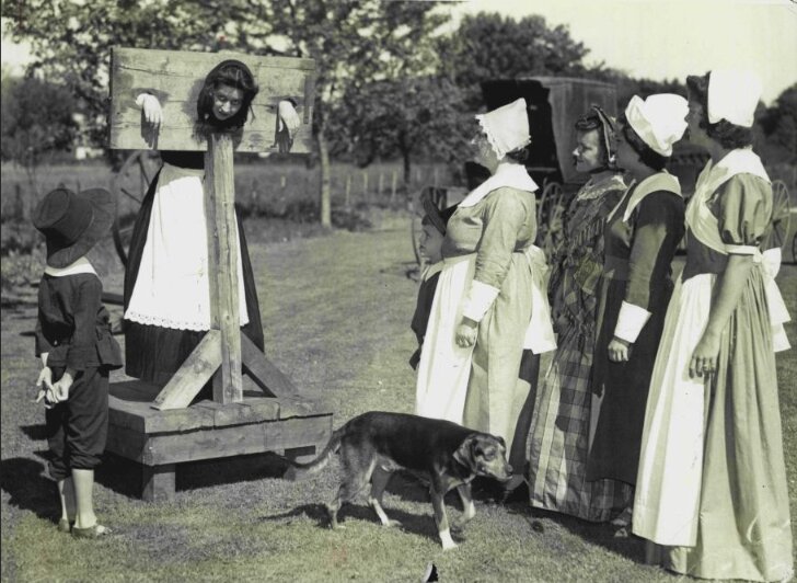 Photo: reenactment of Goody Cole in a pillory. Credit: Lane Memorial Library.