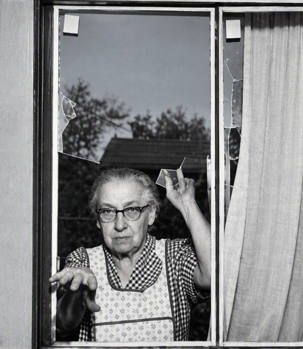 Photo: Mrs. Papineau in front of shattered windows. Credit: Wilma Parker.