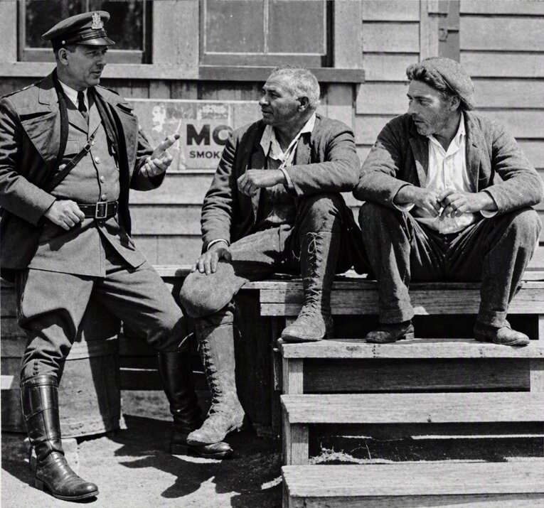 Photo: Mashpee Chief of Police Louis/Lewis Francis Mills (center) in discussion, 1933. Credit: Boston Public Library.